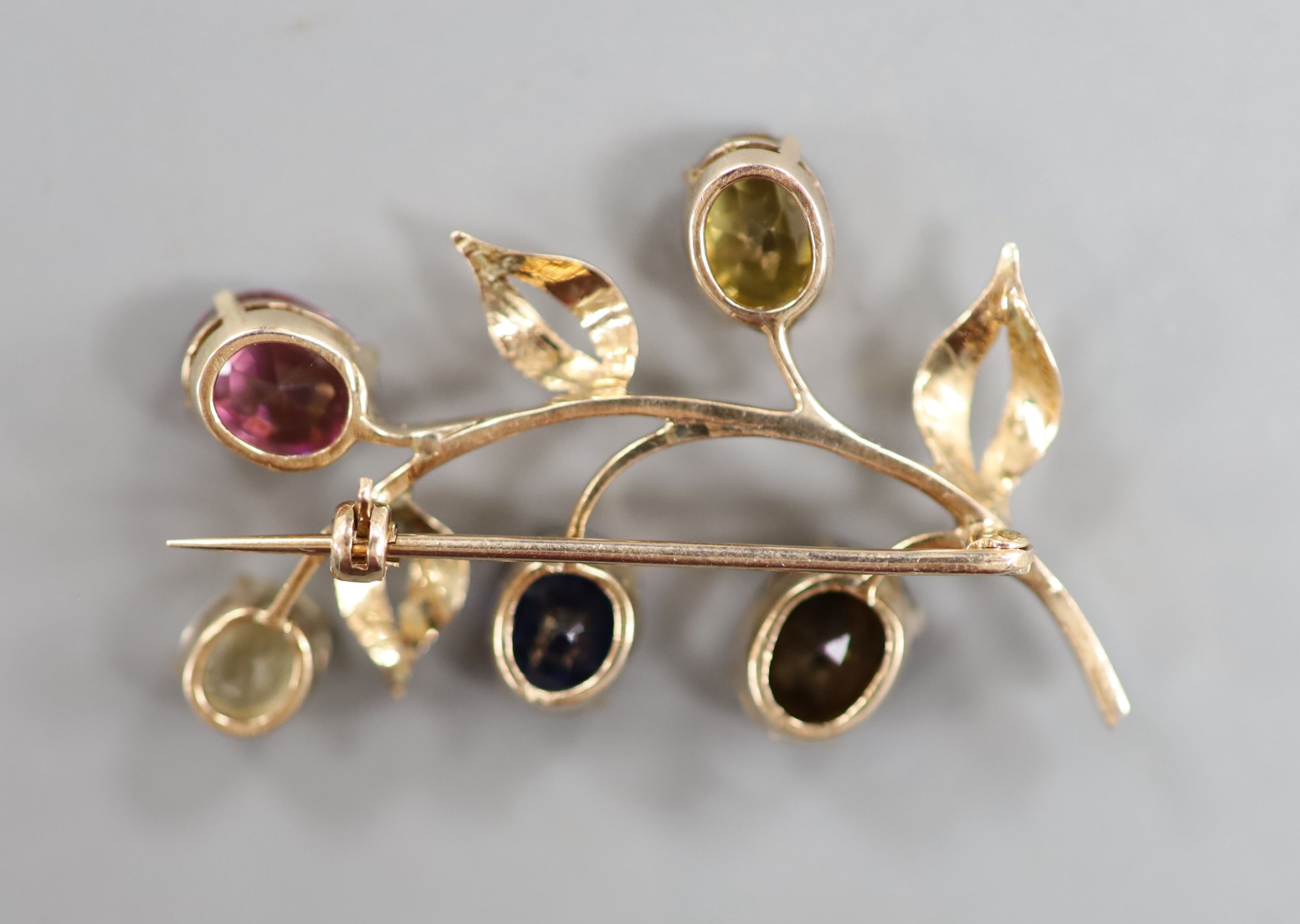 A yellow metal and multi gem set (including sapphire, tourmaline and garnet) floral spray brooch, 35mm, gross weight 4.9 grams